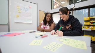 students at desk working together 